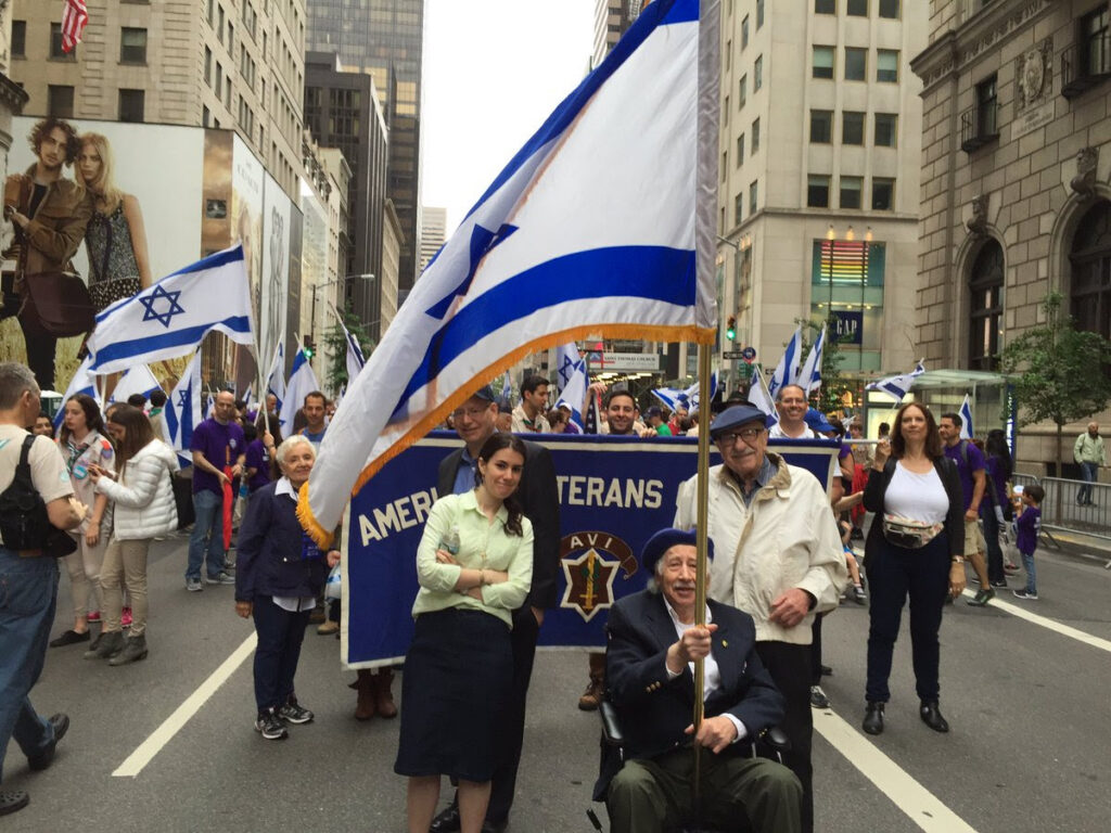 Marcel Berkowitz carrying the Israeli flag at the 2016 Celebrate Israel Parade